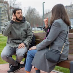 Friends sign to each other in a park